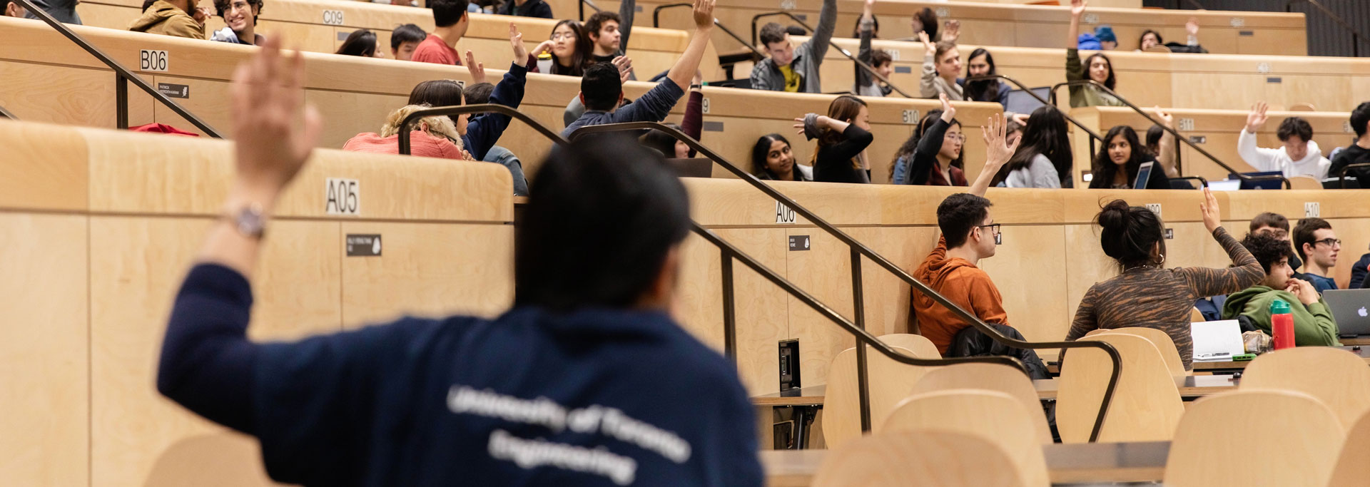 utea-faqs students with hands raised in a class